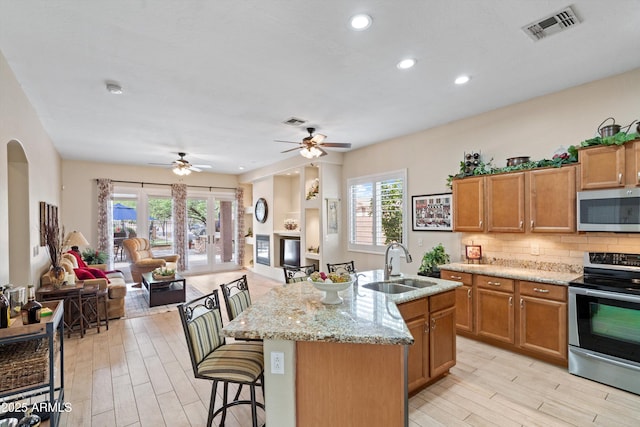 2221 W Calle De Las Estrella Way, Phoenix, AZ 85085 - kitchen with appliances with stainless steel finishes, open floor plan, light wood finished floors, and recessed lighting
