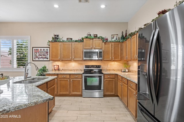 2221 W Calle De Las Estrella Way, Phoenix, AZ 85085 - kitchen with stainless steel appliances, brown cabinets, and recessed lighting