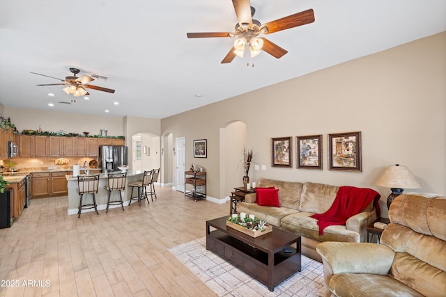 2221 W Calle De Las Estrella Way, Phoenix, AZ 85085 - living area featuring ceiling fan, arched walkways, light wood-style flooring, and recessed lighting