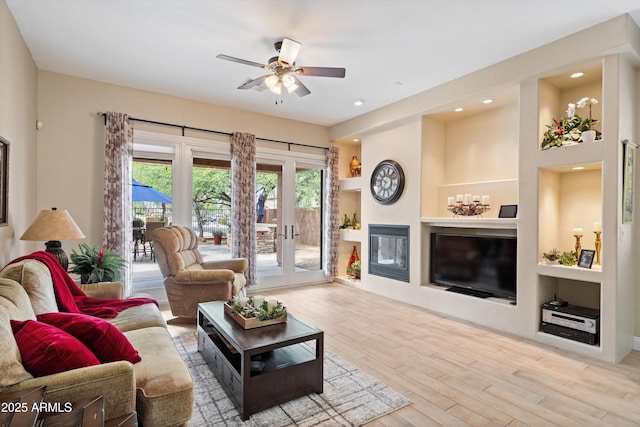 2221 W Calle De Las Estrella Way, Phoenix, AZ 85085 - living area featuring a ceiling fan, wood finished floors, french doors, built in features, and recessed lighting