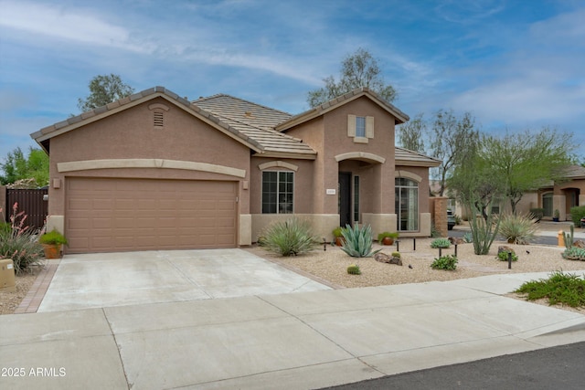2221 W Calle De Las Estrella Way, Phoenix, AZ 85085 - view of front of house with stucco siding, driveway, an attached garage, and a tile roof