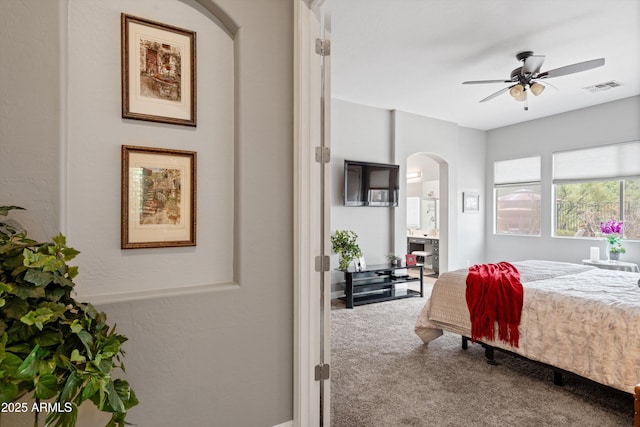 2221 W Calle De Las Estrella Way, Phoenix, AZ 85085 - bedroom featuring arched walkways, carpet floors, and connected bathroom