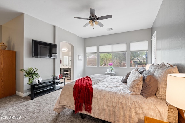 2221 W Calle De Las Estrella Way, Phoenix, AZ 85085 - carpeted bedroom with arched walkways, ensuite bathroom, and ceiling fan