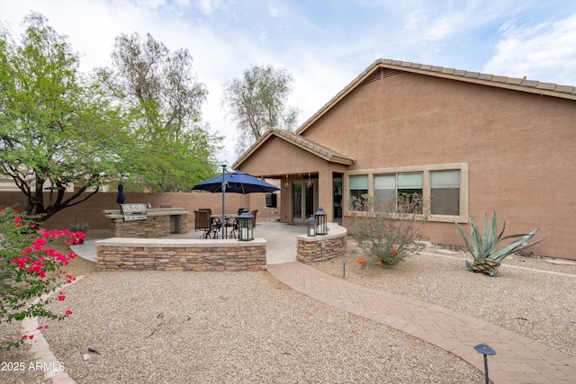 2221 W Calle De Las Estrella Way, Phoenix, AZ 85085 - rear view of house with an outdoor kitchen, a patio area, and stucco siding