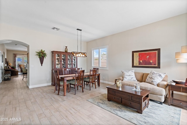 2221 W Calle De Las Estrella Way, Phoenix, AZ 85085 - living room with arched walkways and light wood finished floors