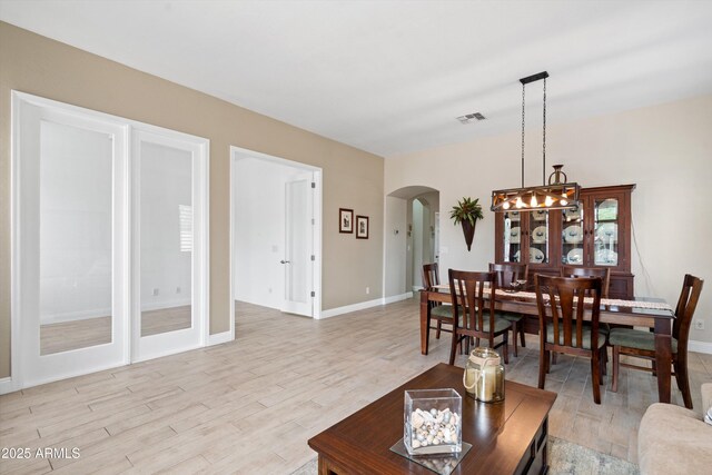 2221 W Calle De Las Estrella Way, Phoenix, AZ 85085 - living area with arched walkways and light wood finished floors
