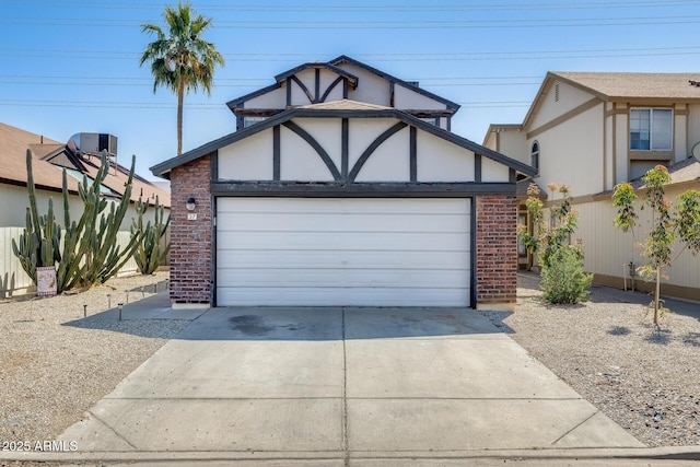 view of front facade featuring brick siding, driveway, and a garage