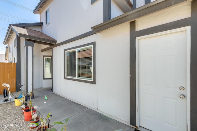 exterior space with a patio, stucco siding, and fence