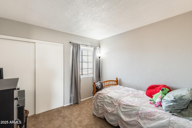 bedroom featuring a closet, carpet flooring, and a textured ceiling