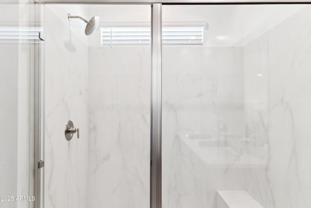 bathroom with a marble finish shower