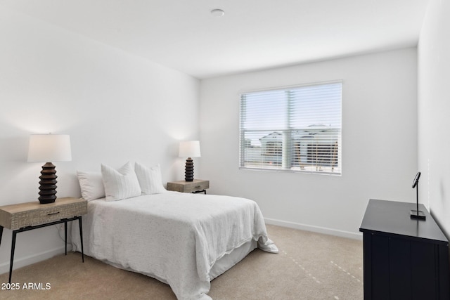 carpeted bedroom featuring baseboards