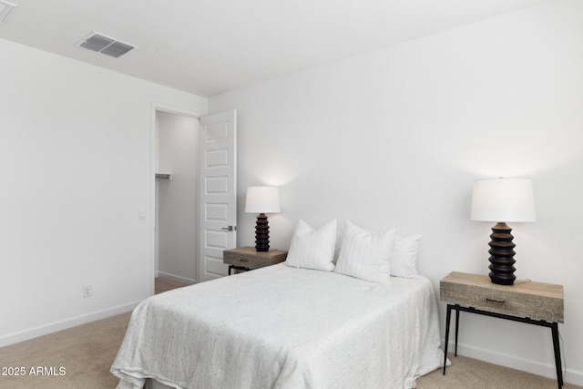 bedroom with visible vents, light carpet, and baseboards