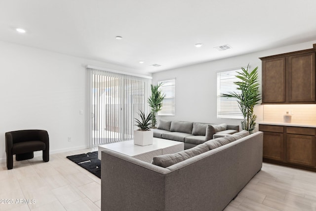 living room with visible vents, recessed lighting, and baseboards