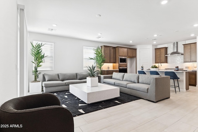 living room with recessed lighting and visible vents