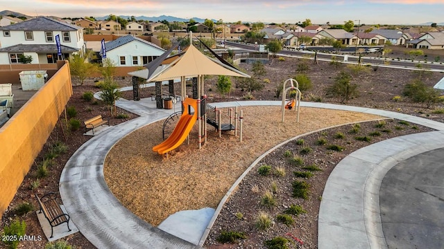 community playground featuring a gazebo, fence, and a residential view