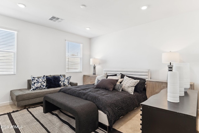 bedroom with light carpet, visible vents, recessed lighting, and baseboards