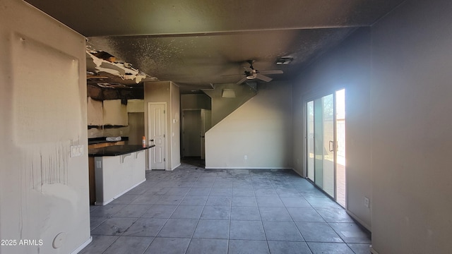 interior space with ceiling fan and light tile patterned flooring