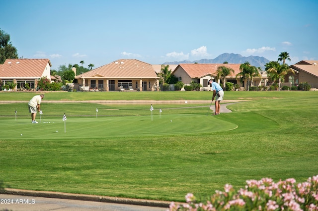 view of community featuring a mountain view and a yard