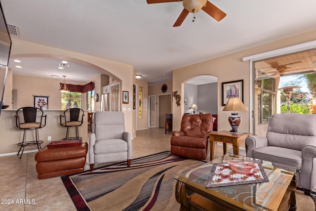 tiled living room featuring ceiling fan