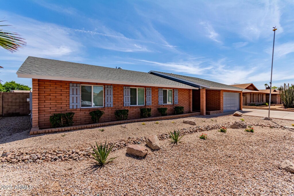 5721 W Palo Verde Ave, Glendale, AZ 85302 - ranch-style house featuring an attached garage, concrete driveway, and a shingled roof