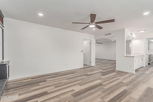 5721 W Palo Verde Ave, Glendale, AZ 85302 - unfurnished living room featuring ceiling fan, light wood-style floors, baseboards, and recessed lighting