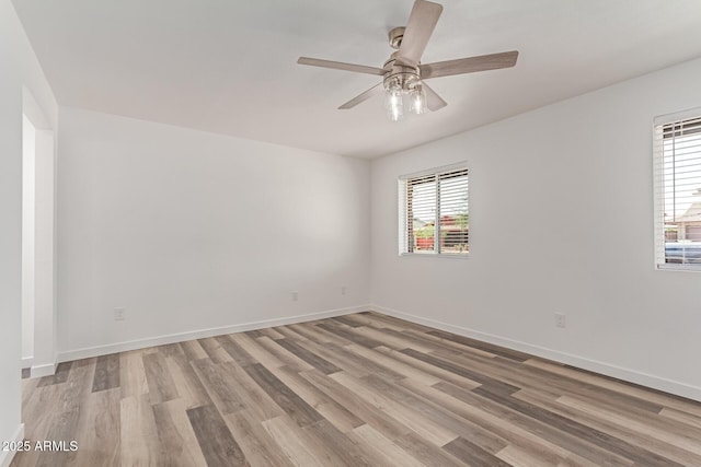 5721 W Palo Verde Ave, Glendale, AZ 85302 - spare room with light wood finished floors, plenty of natural light, a ceiling fan, and baseboards