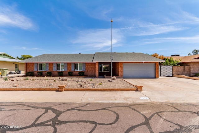 5721 W Palo Verde Ave, Glendale, AZ 85302 - ranch-style house with concrete driveway, a garage, brick siding, and a shingled roof
