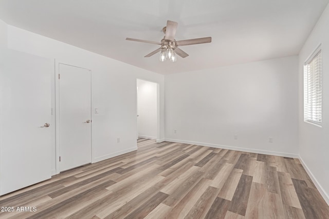 5721 W Palo Verde Ave, Glendale, AZ 85302 - unfurnished bedroom with light wood finished floors, baseboards, and a ceiling fan