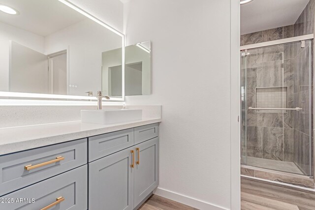 5721 W Palo Verde Ave, Glendale, AZ 85302 - bathroom with wood finished floors, vanity, a shower stall, and baseboards