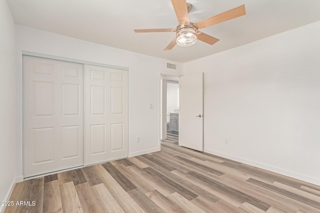 5721 W Palo Verde Ave, Glendale, AZ 85302 - unfurnished bedroom featuring light wood finished floors, a closet, baseboards, and ceiling fan
