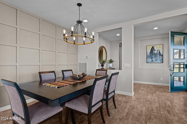 dining area featuring an inviting chandelier and light wood-type flooring