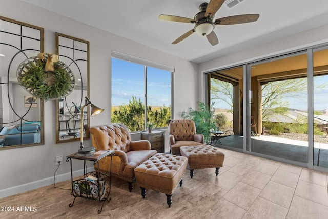 living area featuring ceiling fan and light tile patterned floors