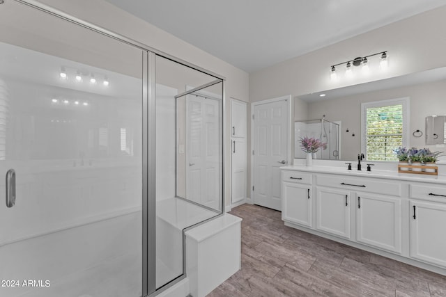 bathroom featuring vanity, a shower with shower door, and hardwood / wood-style flooring