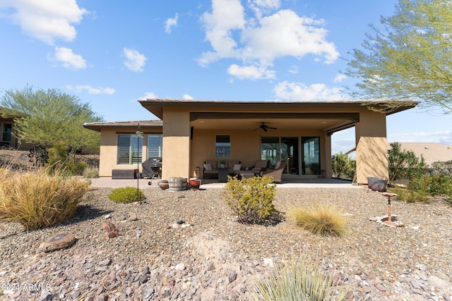 back of property featuring a patio, ceiling fan, and an outdoor hangout area