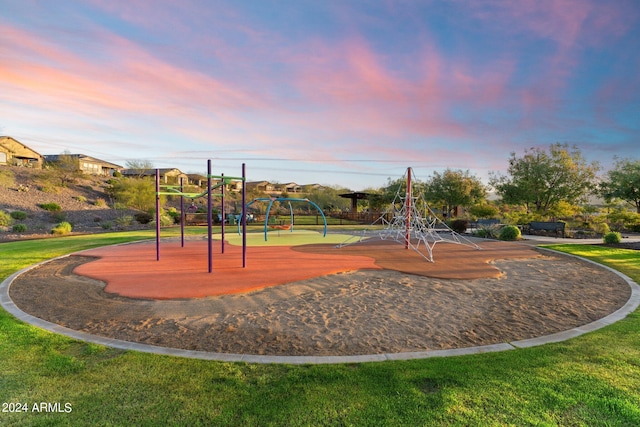 view of home's community with a playground and a yard