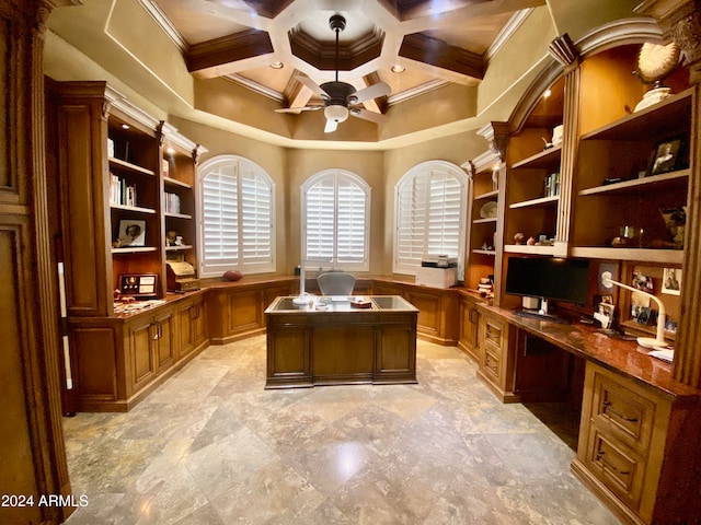 home office with coffered ceiling, ceiling fan, built in desk, ornamental molding, and beam ceiling