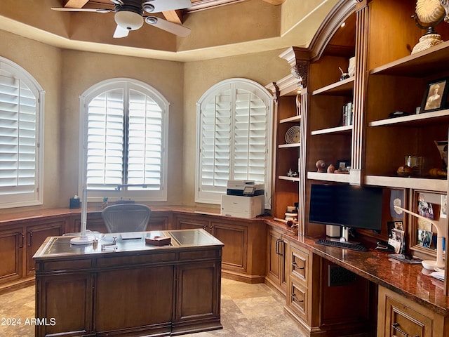 office space featuring ceiling fan and built in desk