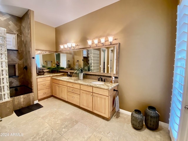 bathroom with a washtub and vanity