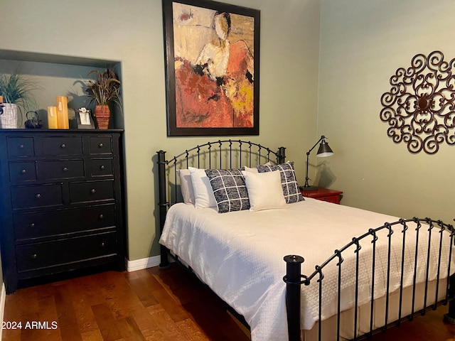 bedroom featuring dark wood-type flooring