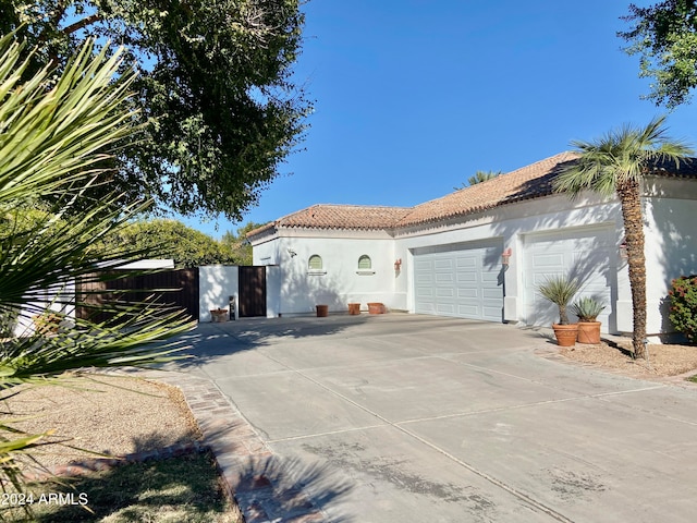 mediterranean / spanish-style home with a garage