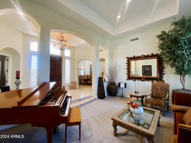 interior space with light carpet, a high ceiling, and a notable chandelier