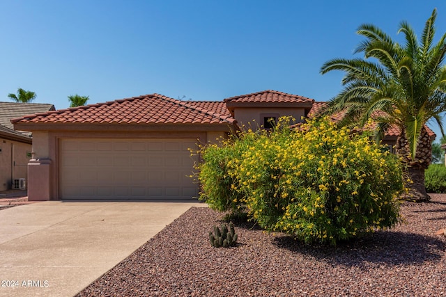 15631 W Bethesda Ct, Surprise, AZ 85374 - mediterranean / spanish house featuring stucco siding, a garage, driveway, and a tiled roof