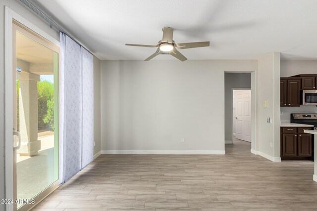 15631 W Bethesda Ct, Surprise, AZ 85374 - unfurnished living room with light wood-style flooring, baseboards, and ceiling fan