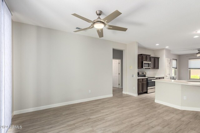 15631 W Bethesda Ct, Surprise, AZ 85374 - unfurnished living room with recessed lighting, baseboards, light wood-style floors, and ceiling fan