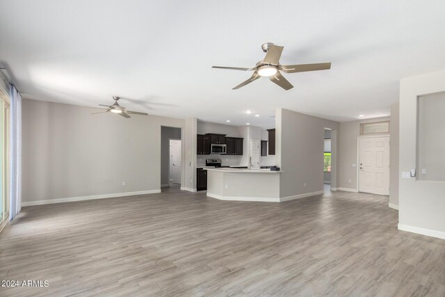 unfurnished living room featuring light hardwood / wood-style flooring and ceiling fan