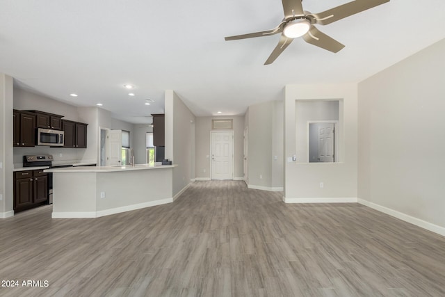 unfurnished living room featuring light wood-type flooring and ceiling fan