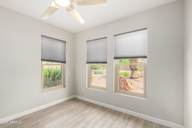 spare room featuring light hardwood / wood-style floors and ceiling fan