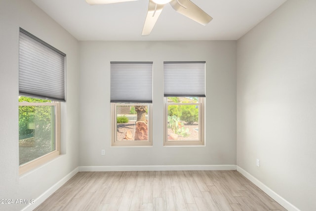 unfurnished room featuring light hardwood / wood-style floors, a wealth of natural light, and ceiling fan