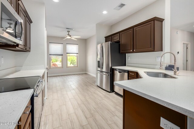 15631 W Bethesda Ct, Surprise, AZ 85374 - kitchen featuring visible vents, light wood-style flooring, appliances with stainless steel finishes, a ceiling fan, and a sink