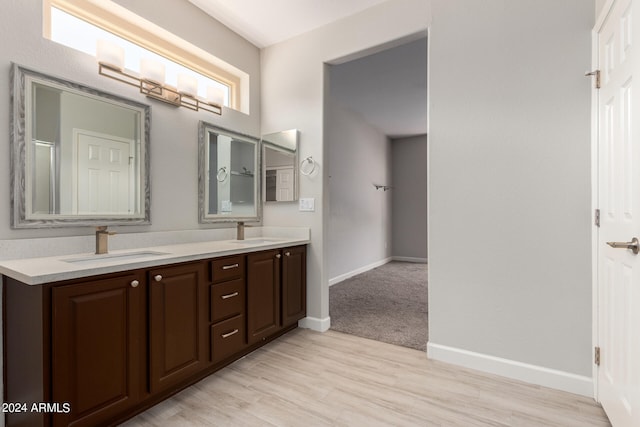 bathroom featuring double vanity and hardwood / wood-style floors